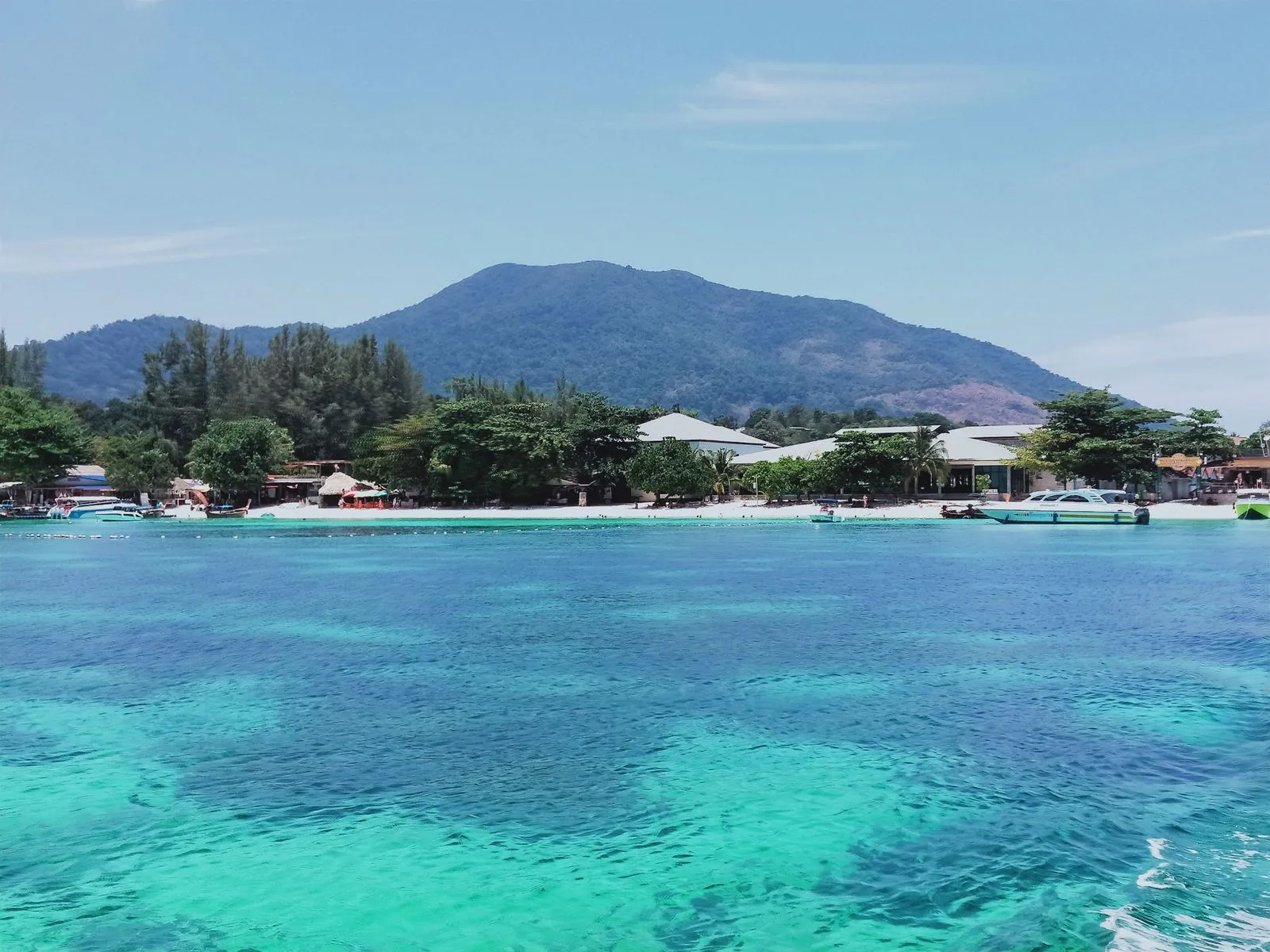 Koh Lipe's beach front seen from the sea, Koh Adang's peak behind