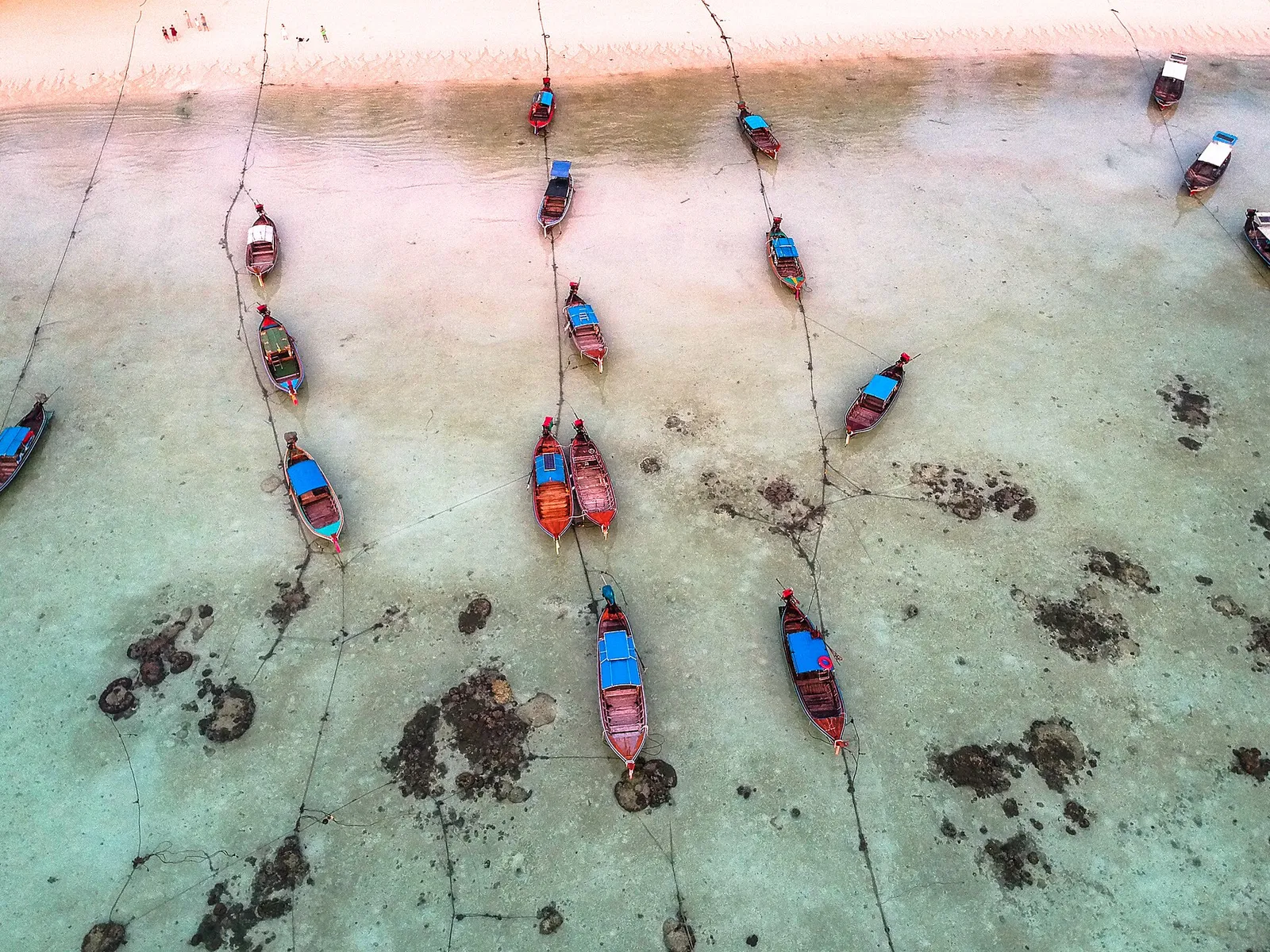 Longtail boats moored in shallow water off Koh Lipe, seen from above