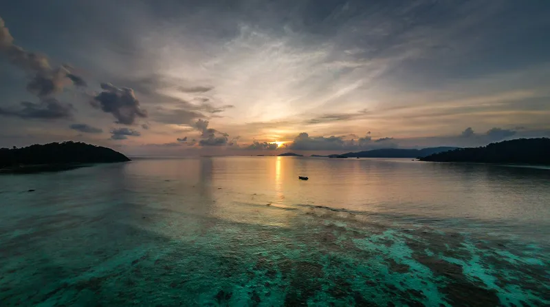 Sunset over shallow reef and islands off Koh Lipe