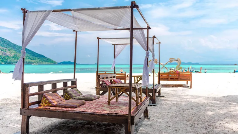 Day beds with white canopies on Sunrise Beach, Koh Lipe
