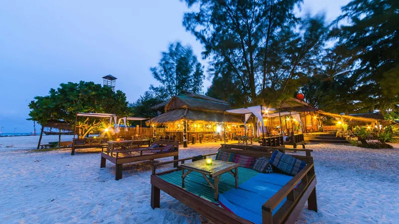 Beach bar lit up at dusk on Sunrise Beach, Koh Lipe
